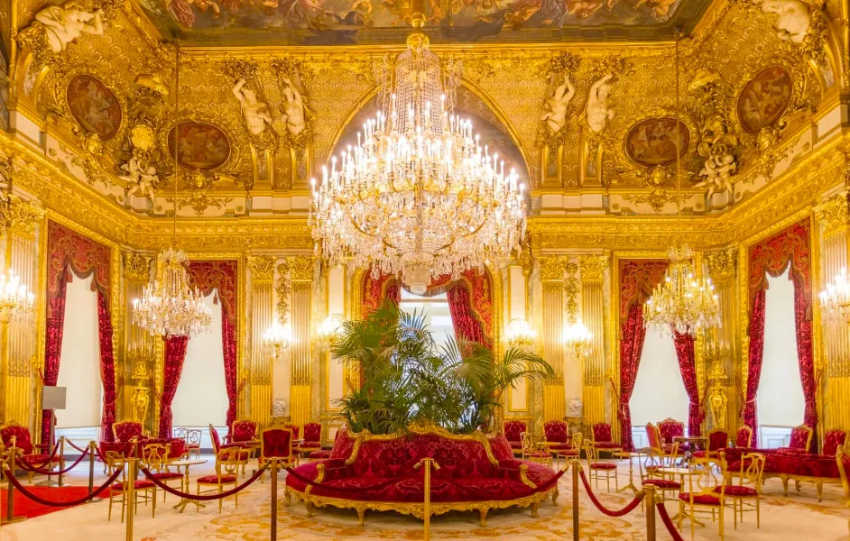 Napoleon III Apartments glowing under chandeliers